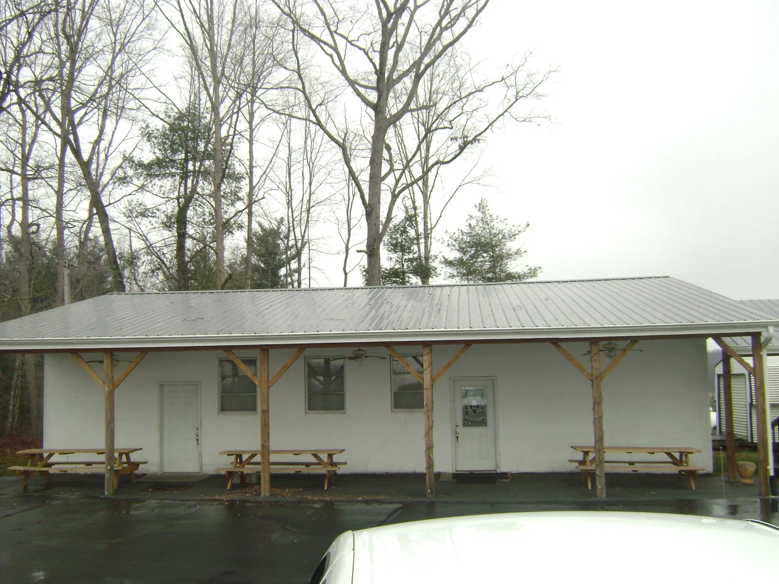 Gray metal roof over a block building with a timber post porch in Edisto Island
