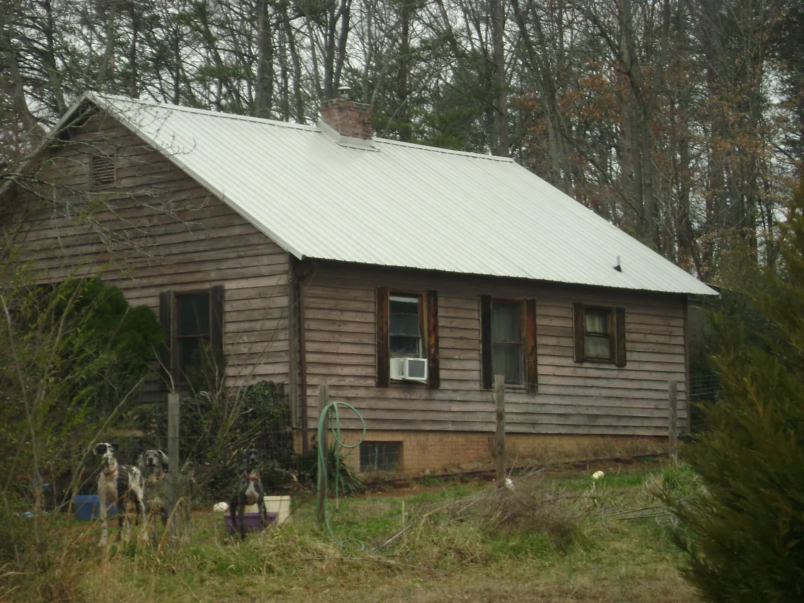 White metal roof on an old wood sided farmhouse, from a Metal Roof Installation job in Edisto Island